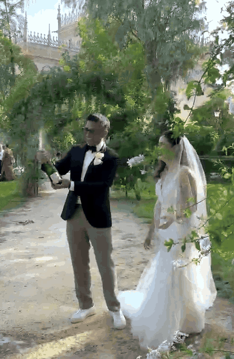 Joelle and Gregory popping champagne in the gardens of the Alcazar, Seville